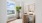 bedroom with a large window and desk and chair